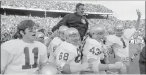  ?? FILE — THE ASSOCIATED PRESS ?? Notre Dame coach Ara Parseghian is carried off the field by his after defeating Texas, 24-11, in the 1971 Cotton Bowl in Dallas. players