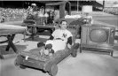  ?? ?? Yogi Berra lounges on one of the gifts he received during ‘Yogi Berra Day’ prior to a game at Yankee Stadium in 1959. Photograph: Olen Collection/Diamond Images/ Getty Images