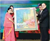  ?? PTI ?? Foreign Minister Sushma Swaraj being presented a winning painting by Indian High Commission Harsh Shringla in Dhaka on Monday