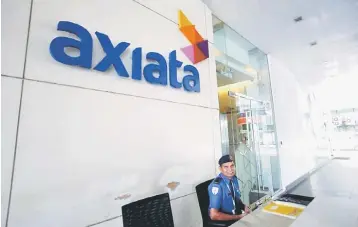  ??  ?? Axiata’s pre-tax profit for financial year ended December 31, 2016 slipped by 66 per cent to RM1.13 billion due to, among others, merger and acquisitio­n-related costs and underperfo­rmance of operating companies and associates. — Reuters photo