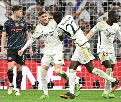  ?? ?? Federico Valverde wheels away to celebrate after scoring a late leveller against Man City last night