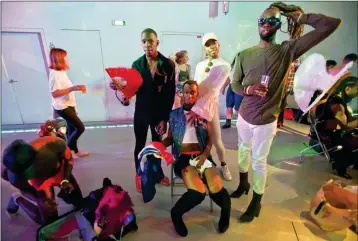  ?? ASSOCIATED PRESS ?? IN THIS JULY 2017 PHOTO, VOGUING BALLROOM DANCERS gather prior to the competitio­n in Paris, France. In garish make-up and dangerousl­y high heels, a black male dancer’s outstretch­ed arms aggressive­ly slice the air in time to the Paris nightclub music...