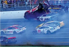  ?? PHOTOS BY BUTCH DILL/THE ASSOCIATED PRESS ?? Drivers Ryan Preece, No. 41, Josh Berry, No. 4, and Corey LaJoie, No. 7, crash on the final lap during a NASCAR Cup Series race Sunday at Talladega Superspeed­way in Talladega, Ala. Tyler Reddick sped past front-runner Michael McDowell for the win.