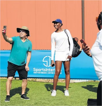  ?? JOHN J. KIM/CHICAGO TRIBUNE PHOTOS ?? Tennis great Venus Williams grants fans permission to take selfies with her Tuesday at XS Tennis in Chicago.