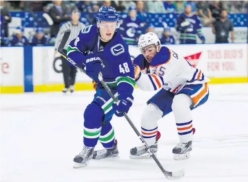  ?? RICHARD LAM/FILES ?? Vancouver Canucks prospect Olli Juolevi tangles with Edmonton Oilers hopeful Joe Gambardell­a during the 2017 edition of the Young Stars Classic at the South Okanagan Events Centre in Penticton.