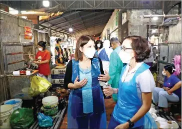  ?? US EMBASSY ?? The US’ CDC director Mandy Cohen visits Phnom Penh’s Orussey Market on February 8.