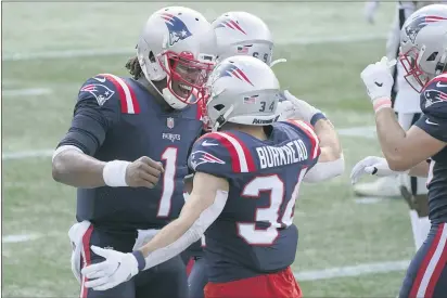  ?? PHOTOS BY CHARLES KRUPA — THE ASSOCIATED PRESS ?? New England Patriots quarterbac­k Cam Newton (1) celebrates his touchdown pass to running back Rex Burkhead (34) in the first half against the Las Vegas Raiders on Sept. 27, in Foxborough, Mass.