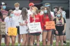  ?? OWEN MCCUE - MEDIANEWS GROUP ?? Chester County athletes hold up their signs during a rally outside the Chester County Health Department on Monday in West Chester.