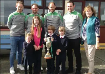  ??  ?? The Boyle brothers, 2017 County Hurling Champions and former pupils of Ballincros­sig NS, Ballyduff pay a visit to the school on Wednesday with the Neilus Flynn Cup, pictured with their nieces and nephews. Also in the picture is their mother Helen Boyle.