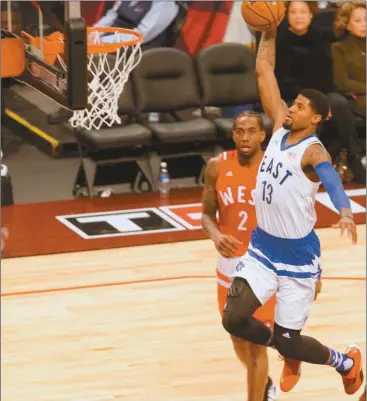  ?? Chris Young/The Canadian Press via AP ?? Eastern Conference’s Paul George, of the Indiana Pacers, (13) scores on the Western Conference’s defense during first half NBA All-Star Game basketball action in Toronto on Sunday, Feb. 14, 2016.