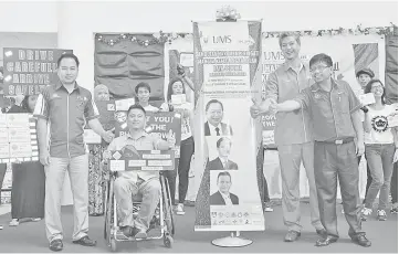  ??  ?? UMS Workers Safety and Health Centre director Shamsul Bahari Shamsudin (second right) and Herdiansah (right) with Fariz (second left) during the launch of the World Day of Remembranc­e for Road Traffic Victims ceremony yesterday.