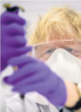  ??  ?? Boris Johnson on a visit to a biotechnol­ogy laboratory – see Q3
