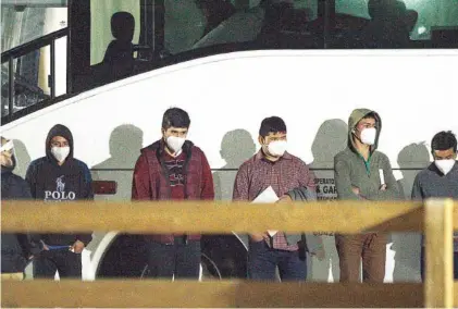  ?? ELI HARTMAN/ODESSA AMERICAN VIA AP ?? Migrant children and teenagers from the southern border of the United State wait to be processed after entering the site of a temporary holding facility Sunday south of Midland, Texas.