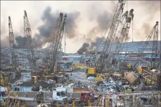  ?? Hassan Ammar / Associated Press ?? Smoke rises in the aftermath of a massive explosion in Beirut, Lebanon, on Tuesday.