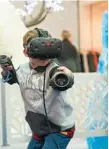  ??  ?? Caleb Webber has fun using Snow Slingers Virtual Reality.