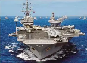  ?? EPA PIC ?? The American nuclear-powered aircraft carrier, the USS Ronald Reagan at sea. The United States takes the position that Unclos preserves the traditiona­l freedom to use the high seas for military purposes in a coastal state’s EEZ.