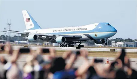  ?? Wilfredo Lee Associated Press ?? AIR FORCE ONE lands in Palm Beach, Fla. At least 27 aircraft have violated airspace restrictio­ns near President Trump’s estate.