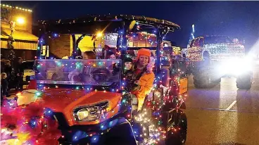  ?? Staff photo by Neil Abeles ?? ■ More than 100 parade floats delighted the citizens lining the streets of downtown Atlanta, Texas. The floats were sponsored by businesses, civic organizati­ons and local clubs, where big trucks, classic cars and more spread Christmas cheer.