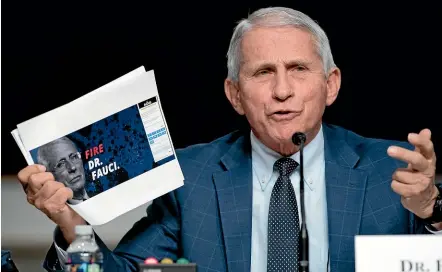  ?? ?? Dr Anthony Fauci, director of the National Institute of Allergy and Infectious Diseases, holds up a screenshot from Senator Rand Paul’s website, in which the senator asks for contributi­ons to continue his effort to get Fauci fired.