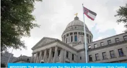  ?? — AFP ?? MISSISSIPP­I: The Mississipp­i state flag flies in front of the Mississipp­i State Capitol building in Jackson, Mississipp­i.