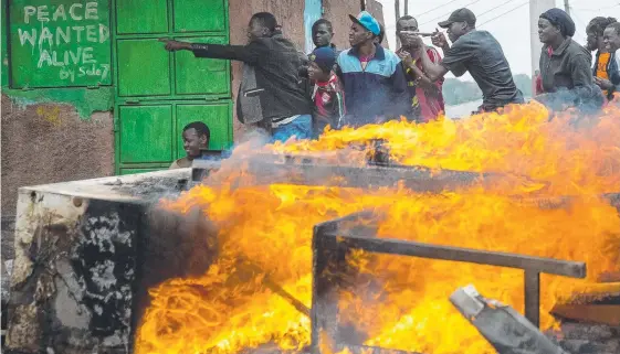  ?? Picture: AFP ?? Supporters of Kenya’s opposition party National Super Alliance take shelter during a protest against President Uhuru Kenyatta.