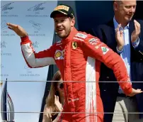  ?? AFP ?? Ferrari’s German driver Sebastian Vettel strikes a pose on the podium after winning the British GP. —