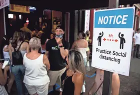  ?? ANDREW NELLES/THE TENNESSEAN ?? Signs remind people to socially distance on Lower Broadway in Nashville on Aug. 7, 2020.