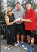  ?? SUBMITTED PHOTO ?? Chester High graduate and former Wisconsin basketball coach Bo Ryan, center, and his wife, Kelly, present a check for $10,000 to Sports Legends of Delaware County Museum president Jim Vankoski for the Emlen Tunnell Statue matching-funds challenge.