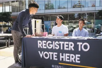  ?? Michael Short / Special to The Chronicle 2018 ?? A voter registrati­on drive at UC Berkeley in 2018. A state appeals court on Tuesday rejected an effort to add such services to certain state offices that deal with disabled and elderly residents.