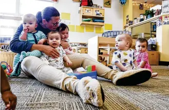  ?? NICK GRAHAM / STAFF ?? Lead teacher Krystal Whittamore tells a story to children in the nursery classroom at the Mini University at Miami University Child Developmen­t Center in Oxford on April 6.