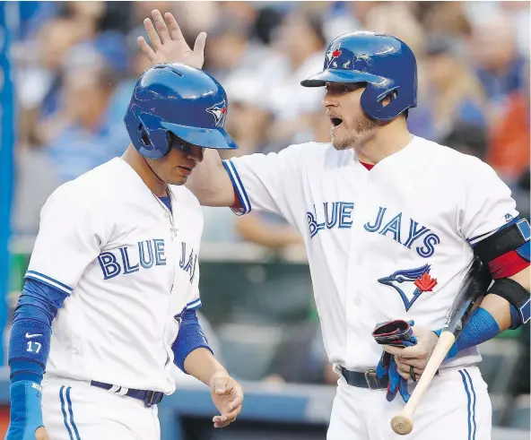  ?? — THE CANADIAN PRESS ?? Josh Donaldson, right, is too valuable to the Toronto Blue Jays for the team to consider trading him before next week’s non-waiver deadline. Donaldson, who turns 32 in December, doesn’t see any reason why he can’t be effective now and for years to come.