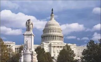  ?? J. Scott Applewhite / Associated Press ?? The U.S. Capitol is seen as the House is set to begin public impeachmen­t inquiry hearings as lawmakers debate whether to remove President Donald Trump from office on Tuesday. At left is the Peace Monument.