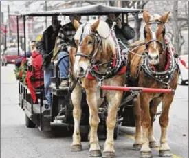  ?? ?? The German Village Christmas Walk in Hamilton, an annual event that started in 1992, gives people the opportunit­y to view some of the historical houses in the historic district as well as enjoy carriage rides, face-painting, visits with Santa and holiday music.