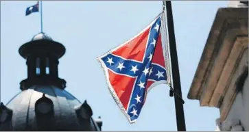  ?? Joe Raedle
Getty I mages ?? SOUTH CAROLINA Gov. Nikki Haley has advocated hauling down the Confederat­e battle f lag on statehouse grounds. Above, the f lag at the state’s Capitol a day after her announceme­nt.