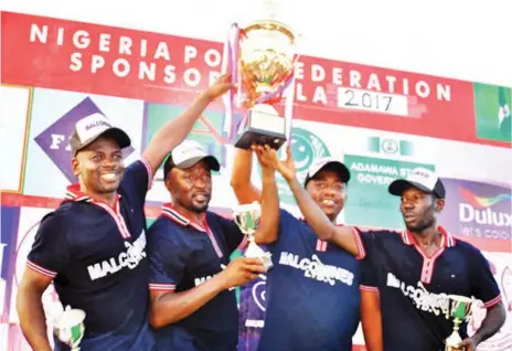  ??  ?? Jos Malcomines Patron, Murtala Laushi, (3rd from left) and his players showcasing the Governor Cup they won two years ago.