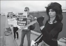  ?? CHARLIE NEUMAN/SAN DIEGO UNION-TRIBUNE FILE PHOTOGRAPH ?? Nasim Najafi Aghdam, right, takes part in an animal rights protest outside Camp Pendleton in 2009.