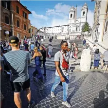  ??  ?? Ismael from Belize walks with tourists from the Spanish Steps in central Rome