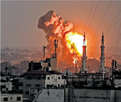  ??  ?? A fireball engulfs part of Gaza City as the Israeli bombardmen­t went on yesterday