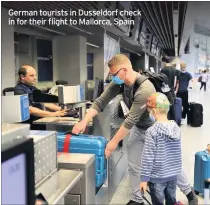  ??  ?? German tourists in Dusseldorf check in for their flight to Mallorca, Spain