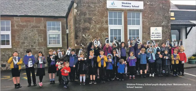  ??  ?? Shiskine Primary School pupils display their ‘Welcome Back to School’ banner.