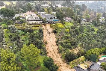  ?? Allen J. Schaben Los Angeles Times ?? GEVORG TERTERYAN’S home, at left, was one of two that were yellow-tagged after a mudslide struck the 400 block of Paulette Lane in La Cañada Flintridge. “We're thankful to God we're OK,” the 55-year-old said.