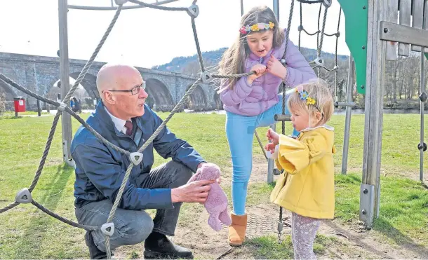  ??  ?? IN SPOTLIGHT: John Swinney, seen meeting two young sisters, Torra, two, and Alba, seven, at Dunkeld Play Park, was asked about his future role.