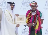  ??  ?? Mohamed bin Zayed Al Nahyan presents the prize to Foetasi Taukave during the Zayed Future Energy Prize awarding ceremony on Monday.