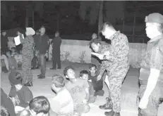  ??  ?? Screening of those rounded up during the operation at Gugusan Felda Umas-umas in Tawau yesterday.