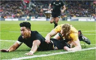  ??  ?? Space out wide: Julian Savea scores New Zealand’s third try