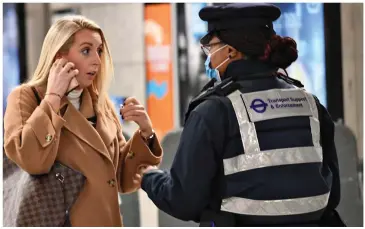  ?? ?? I’ll call you back: Maskless commuters in the capital were confronted by Transport for London staff yesterday. Fines can now rise to £6,400