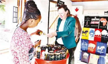  ?? ?? ▲The EU Head of Cooperatio­n tasting Black Mamba foods, chillies and chutney.