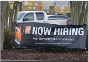  ?? (AP/Rogelio V. Solis) ?? A roadside banner last week beckons to job applicants outside a Home Depot store in Hattiesbur­g, Miss. The number of Americans applying for unemployme­nt benefits rose by 61,000 last week to 719,000.