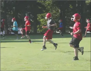  ?? The Sentinel-Record/Richard Rasmussen ?? BACK AT WORK: Wolf Stadium.
Football players at Lake Hamilton run through agility drills during practice at