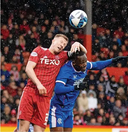  ?? Picture: Shuttersto­ck ?? Aberdeen’s Ross McCrorie climbs above Rabbi Matondo, of Rangers, to win a header